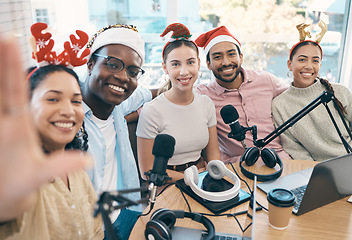 Image showing Christmas portrait, podcast and group selfie of friends, live streaming and people recording broadcast together in studio. Smile, radio host team and picture for xmas at table, holiday or celebration