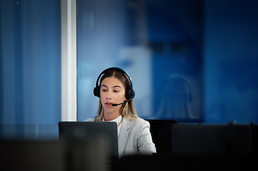 Image showing Business woman, call center and laptop for communication, technical support and information technology advice at night. Professional agent, consultant or advisor speaking on computer at tech company