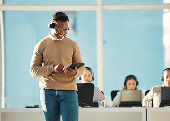 Image showing Happy black man, call center or manager with tablet in customer service, tech support or telemarketing. Contact us, leader or African sales consultant agent networking or typing on technology for CRM