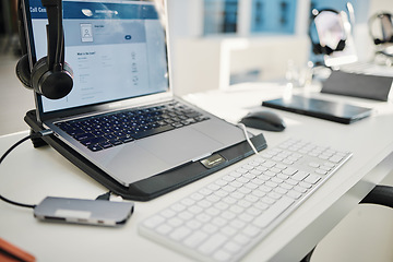 Image showing Empty office, call center and headphones with laptop, keyboard and furniture for telemarketing with voip tech. Help desk, computer and customer service for contact us, technical support or consulting