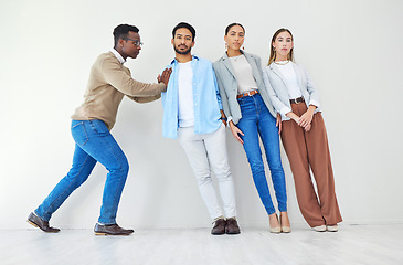 Image showing Serious man pushing team of business people, portrait and together in creative startup office for synergy. Strong professional support group of employees, solidarity in collaboration or cooperation