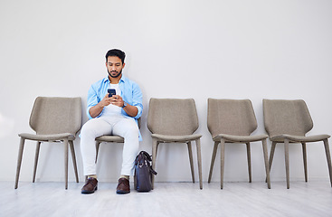 Image showing Waiting room, hiring and man on a phone in office for interview in job search for appointment. Recruit, career and male person networking on cellphone for meeting with human resources in workplace.