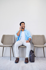 Image showing Waiting room, phone call and man in an office for interview in job search for appointment. Hiring, career and Indian male person on mobile conversation for recruitment meeting with hr in workplace.