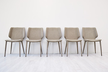 Image showing Interview, empty chair and waiting room by wall background in office and hiring for job. Human resources, furniture and seating area for recruitment, minimalist and advertising vacancy or position