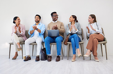 Image showing Business people, presentation and applause with smile in waiting room for interview, recruitment or we are hiring in a row. Men, women and group together for process, career and resume at company