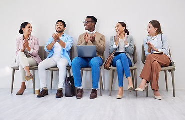 Image showing Business people, clapping hands and recruitment with smile in waiting room for interview or we are hiring at company. Men, women and group together for process, career and onboarding with applause