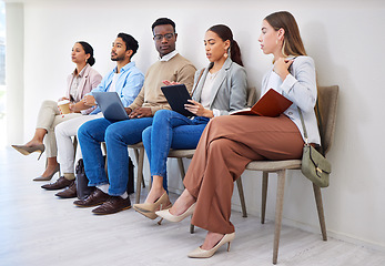 Image showing Business people, row and technology for interview, recruitment or hiring process in waiting room. Men, women and group together for career, onboarding or opportunity at company with diversity or web