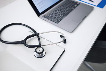 Image showing Stethoscope, laptop and desk for healthcare background, medical research and hospital services or planning. Computer, heart equipment and clinic information, cardiology or telehealth in empty office