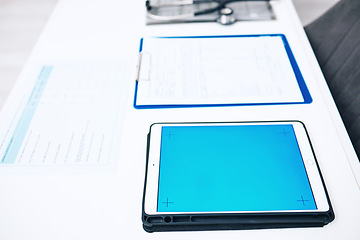 Image showing Tablet, screen space and medical documents in healthcare background, services and results on blue app or mockup. Digital technology, paperwork and empty clinic for registration, data or health charts