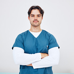 Image showing Nurse, portrait and man with arms crossed for healthcare in studio on white background or mock up space. Medicine, doctor and professional employee with serious face for service, trust and career