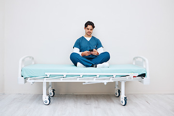 Image showing Phone, nurse and man typing on bed in hospital, telehealth or relax on break on mockup space. Smartphone, stretcher and medical professional on internet, social media or communication on health app