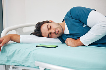 Image showing Sleeping, hospital and tired doctor with phone on bed for rest, nap and break for burnout, exhausted and fatigue. Healthcare, night shift and worker relax for medical service, wellness and stress