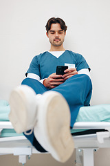 Image showing Phone, nurse and man on bed to relax in hospital, typing email on break and telehealth. Smartphone, serious medical professional on internet and social media for communication on health app in clinic