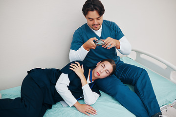 Image showing Doctors, friends and sleeping in picture for social median phone in clinic, joke and silly or goofy. Medical professionals, fun and comedy on break, tired and fatigue from work, hospital bed and rest