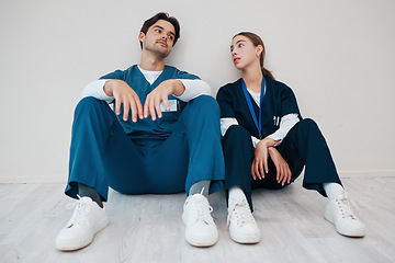 Image showing Nurses, serious couple and relax in hospital, talking and communication. Medical workers, man and woman on break, conversation and healthcare team bonding, support and connection for love in clinic