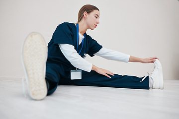 Image showing Hospital, medical and a nurse stretching on the floor of a studio, getting ready for healthcare or treatment. Legs, warm up and a confident young volunteer or medicine professional on mock up