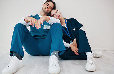 Image showing Sad doctors, hospital floor and woman with man, support and lost with regret, death and fail in surgery. Medic, partnership and burnout with depression, mistake or anxiety for healthcare in clinic