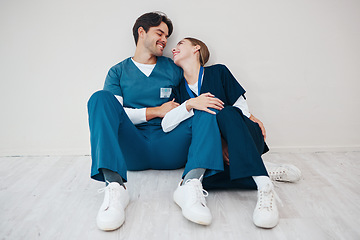 Image showing Happy nurses, couple and relax in hospital, talking and communication. Medical workers, man and woman smile on break, conversation and healthcare team support, love connection and mockup in clinic