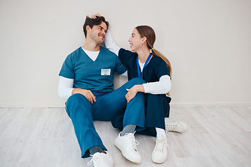 Image showing Nurses, smile of couple and relax in hospital, talking and communication. Happy medical workers, man and woman on break, conversation and healthcare team support, love connection and mockup space