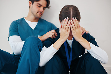 Image showing Crying doctors, hospital floor and woman with man, support or empathy for regret, death or fail in surgery. Medic, partnership and burnout with depression, mistake or anxiety for healthcare in clinic