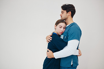 Image showing Doctor, colleagues and tired fatigue or support at healthcare clinic, work stress or hug. Medical professionals, friends or helping comfort in scrubs on wall background, mockup or burnout at hospital