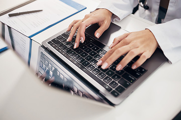 Image showing Female doctor, hand and typing on laptop in office for communication, consultation or treatment in closeup. Woman, nurse and technology for telehealth, medicine or insurance with results by internet