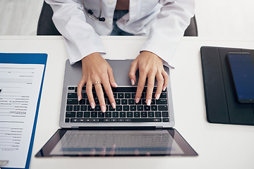 Image showing Laptop, hands or doctor typing research, medical update or telehealth web service in hospital clinic. Woman, top view or surgeon working in professional healthcare with digital tech for email or news