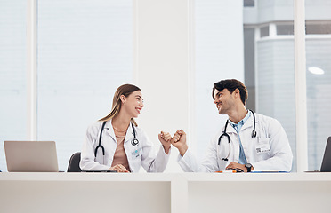 Image showing Man, woman and doctors with fist bump, teamwork and agreement with healthcare, cooperation and smile. Happy people, medical professionals and coworkers with handshake, collaboration and celebration