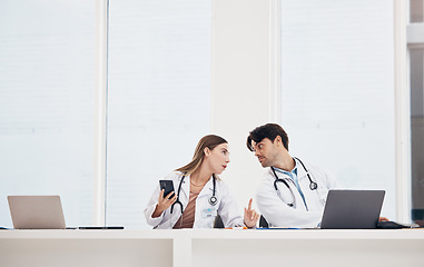 Image showing Doctors, reception desk and colleagues with phone for communication, healthcare planning or research for medical schedule in hospital. Medicine, man and woman with collaboration or working together