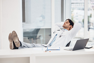 Image showing Man, doctor and sleeping in relax for done, completion or finished at hospital office. Tired male person or medical surgeon chilling on break, rest or asleep lying with feet on work desk at clinic