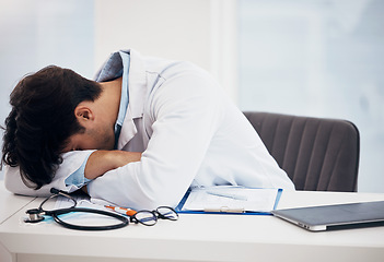 Image showing Man, doctor and sleeping for break, relax or burnout on desk in mental health or mistake at hospital office. Tired male person or medical surgeon chilling in rest or asleep on work desk at clinic