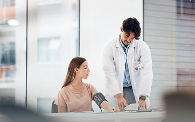 Image showing Doctor, woman and blood pressure machine for hypertension, health assessment or check up at hospital. Healthcare, professional or person with monitor, digital equipment or exam for wellness at clinic