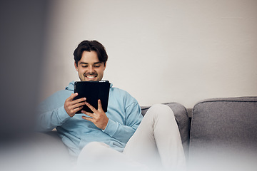 Image showing Happy man, tablet and relax on sofa for social media, communication or entertainment in living room at home. Male person, smile and lying on lounge couch with technology for online streaming at house