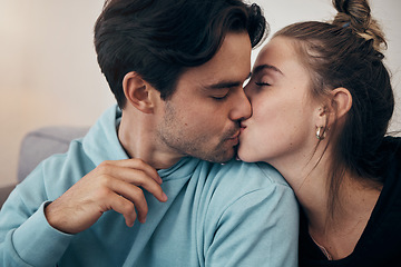 Image showing Couple, relax and kiss on sofa with love in home, living room or house with happy, partnership or marriage. Romantic, people and bonding with man and woman in affection for support and care together