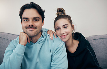 Image showing Smile, portrait and couple relax on a sofa with care, hug and support at home together. Love, face and happy young people in a living room bonding, chilling and enjoy weekend, relationship or day off