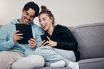 Image showing Couple, phone and tablet with relax on sofa for social media, internet scroll and funny meme with laugh. People, man or woman on couch with smartphone and touchscreen for technology and web streaming