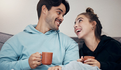 Image showing Couple, coffee and relax with smile, love and trust on sofa in living room of home or apartment with bonding. Tea, man and woman together with happiness for peace, romance and commitment on couch