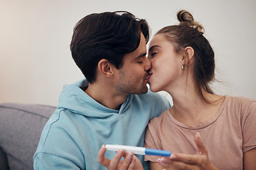 Image showing Pregnancy, test and couple kiss in home living room for good news or positive results. Romance, man and pregnant woman with stick on sofa together happy at success, future maternity or ivf fertility