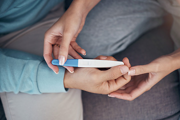 Image showing Couple, hands and holding of pregnancy test in closeup for family planning, future and love on sofa in space. Man, woman and married with result on stick for news of fertility with support for care