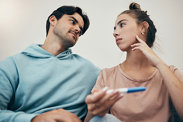 Image showing Couple, pregnancy test and stress in home for infertility, anxiety or support. Woman, or male person or frustrated ovulation news or waiting information fear for loss, relationship problem or comfort
