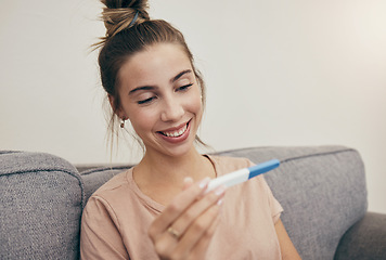 Image showing Pregnancy test, smile and woman on sofa in home, reading good news and check positive results. Pregnant, stick and happy mother in living room excited for success, future maternity and ivf fertility