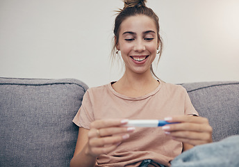 Image showing Pregnancy test, happy and woman on sofa in home, reading good news and check positive results. Stick, smile and pregnant mother in living room excited for success, future maternity and ivf fertility