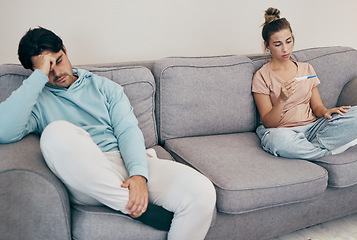 Image showing Pregnancy test, stress and couple on a sofa angry, fighting or argue in their home. Pregnant, conflict and frustrated people in a living room upset with infertility criss, loss or ivf treatment fail