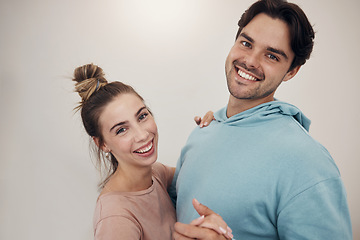 Image showing Portrait, smile and couple dance in a house with music, fun and bonding in their home. Face, hug and happy people dancing to podcast, radio or hifi, laughing and enjoy relationship on wall background