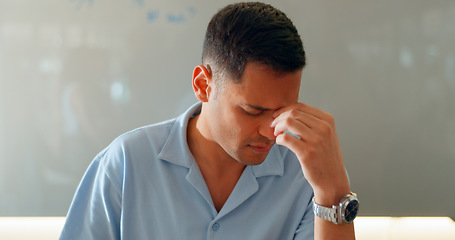 Image showing Stress, headache and a business man in the office for an audit while thinking about tax or compliance. Burnout, pain or pressure with a frustrated young employee in the workplace for a deadline