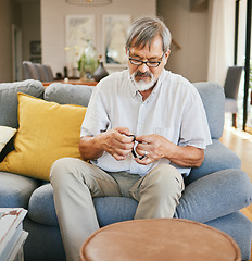 Image showing Home, wrist watch and senior man on sofa to repair, fix wristband and set alarm in living room. Retirement, house and elderly person sitting on couch check clock for time, countdown and timer