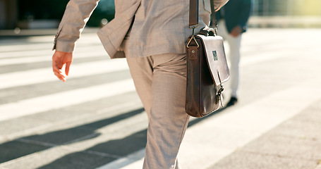 Image showing Businessman, walk and city street closeup or morning work commute, briefcase or professional. Male person, legs or corporate employee fashion or suit leather bag, public travel for career on sidewalk