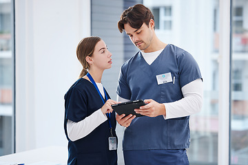 Image showing Doctors, man and woman with tablet at hospital with discussion, healthcare and teamwork. Medical professional, nurse and surgeon with digital app for telehealth, insurance website and clinic advice