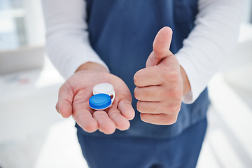 Image showing Nurse, hands and contact lenses with thumbs up in clinic, vision and reading prescription in container. Man, optometrist and emoji for yes for eyecare, closeup and optometry with positive feedback