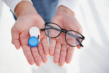 Image showing Eye care, hands of doctor with glasses and contact lens in case for vision, help with eyesight and choice. Eyecare, decision and sight, man giving lenses in container and frame for eyewear option.